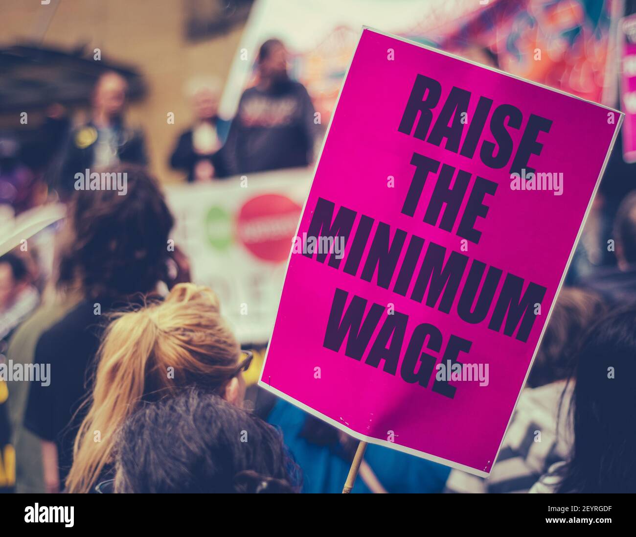 A Raise The Minimum Wage Sign At Worker's Rights Protest Or Rally Stock Photo