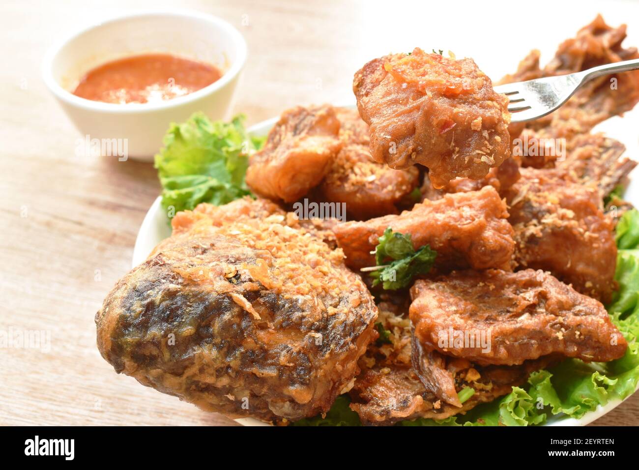 batter fried slice mango or red Tilapia fish with chop garlic dipping