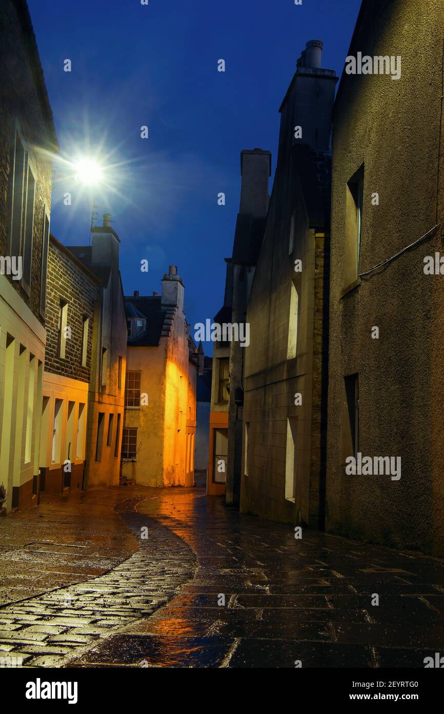 Colourful street lights in scottish town Stromness on Orkney islands with narrow picturesque street Stock Photo