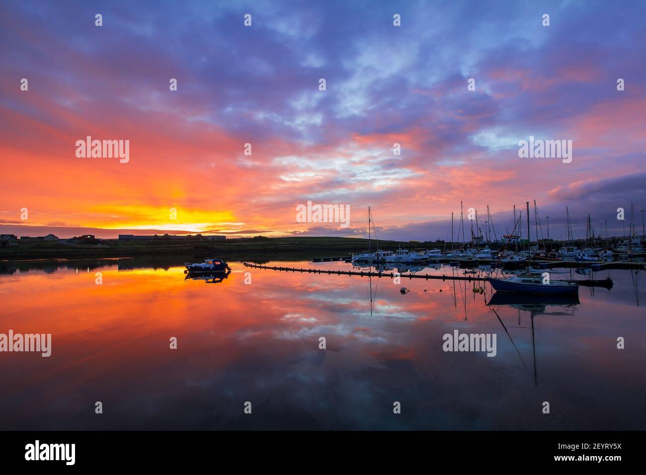 Colorful morning in Stromness marina on Orkney islands in northern Scotland with sky reflection in water Stock Photo