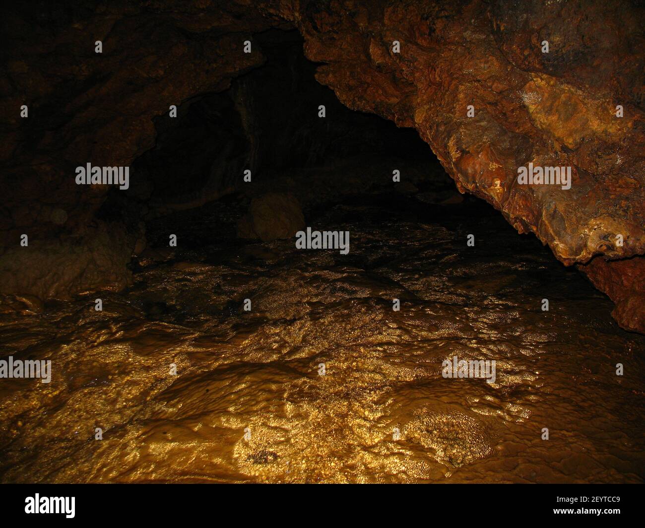 cave passages deep underground, golden bottom Stock Photo Alamy