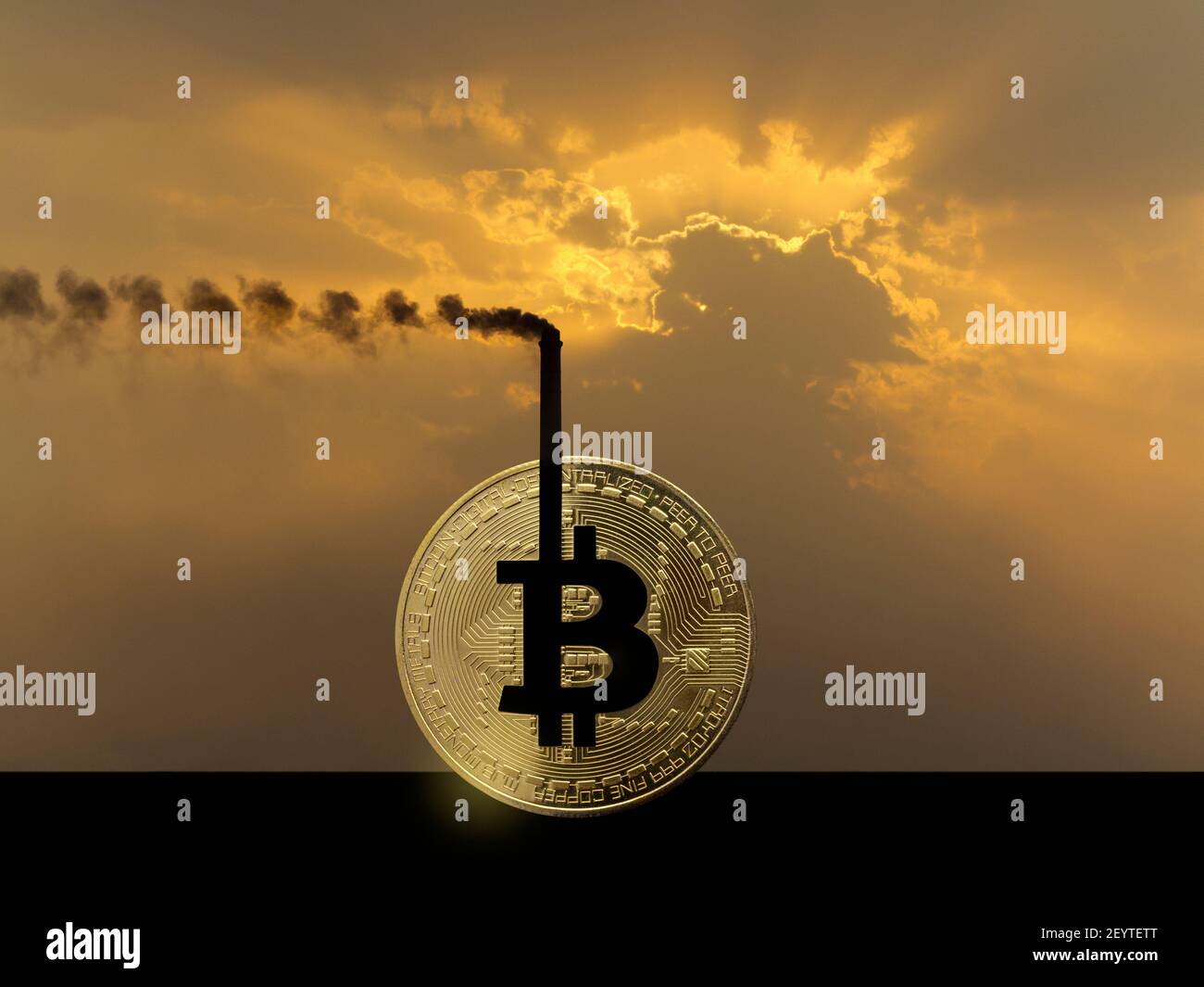 A smoking industrial chimney forming part of a bitcoin token against a dramatic orange sky illustrating the power consumption of cryptocurrency Stock Photo