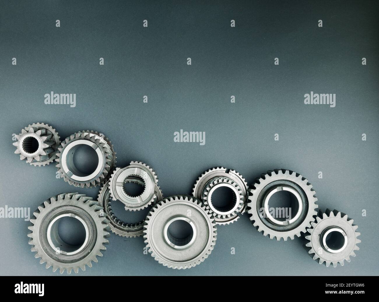 Industrial gears and cogs on paper background. Copy space Stock Photo Alamy
