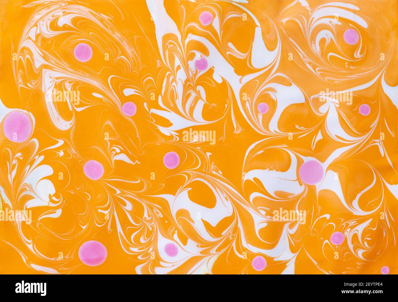 Abstract marbling ebru colorful orange background with waves and pink blots Stock Photo