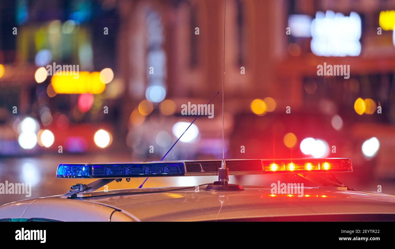 Police car lights at night city street. Red and blue lights. Road traffic accident. Evening patrolling Stock Photo