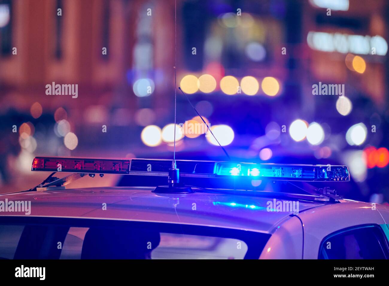 Police car lights at night city street. Red and blue lights. Road traffic accident. Evening patrolling Stock Photo