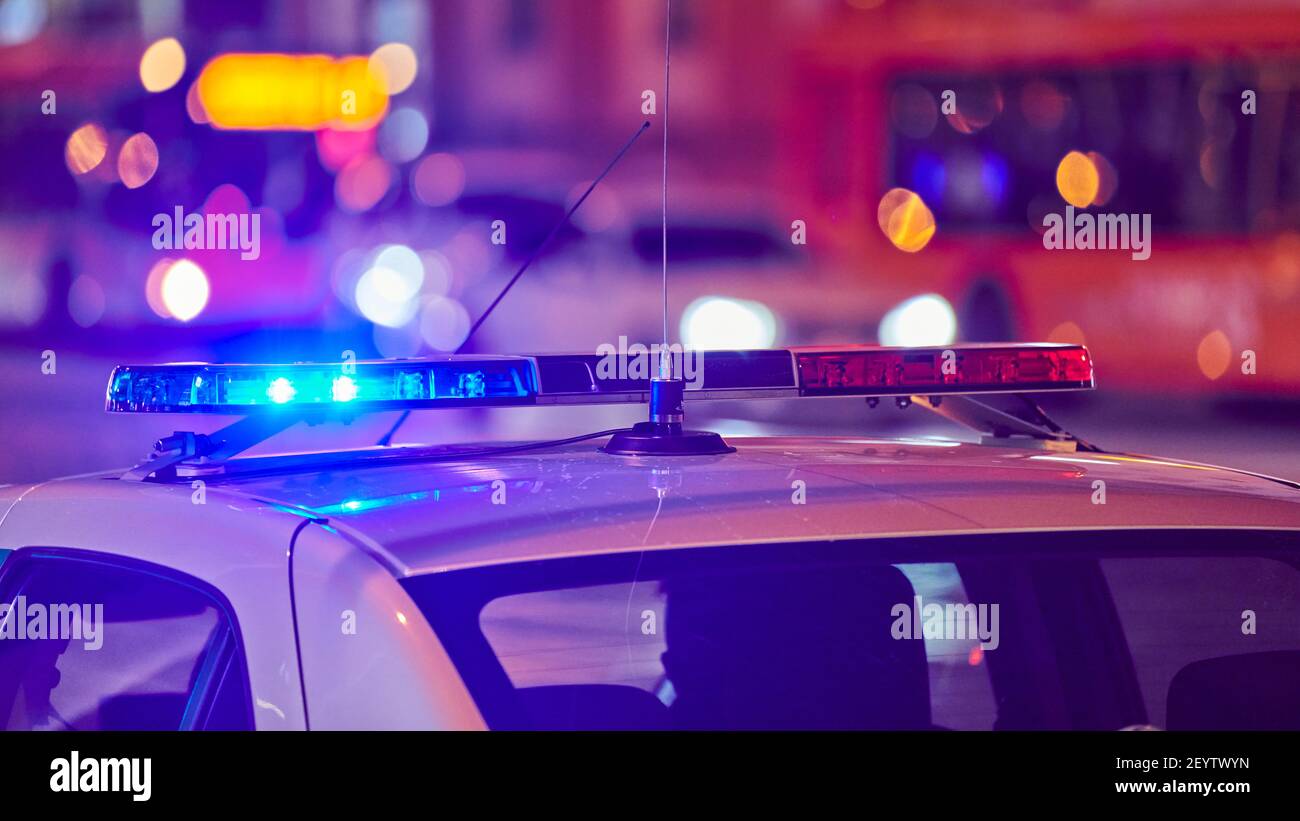 Police car lights at night city street. Red and blue lights. Road traffic accident. Evening patrolling Stock Photo