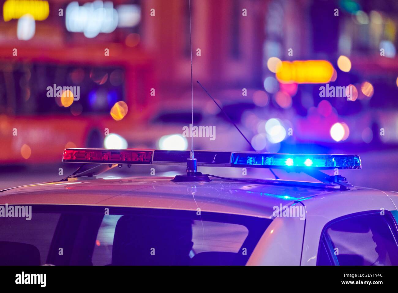 Police car lights at night city street. Red and blue lights. Road traffic accident. Evening patrolling Stock Photo