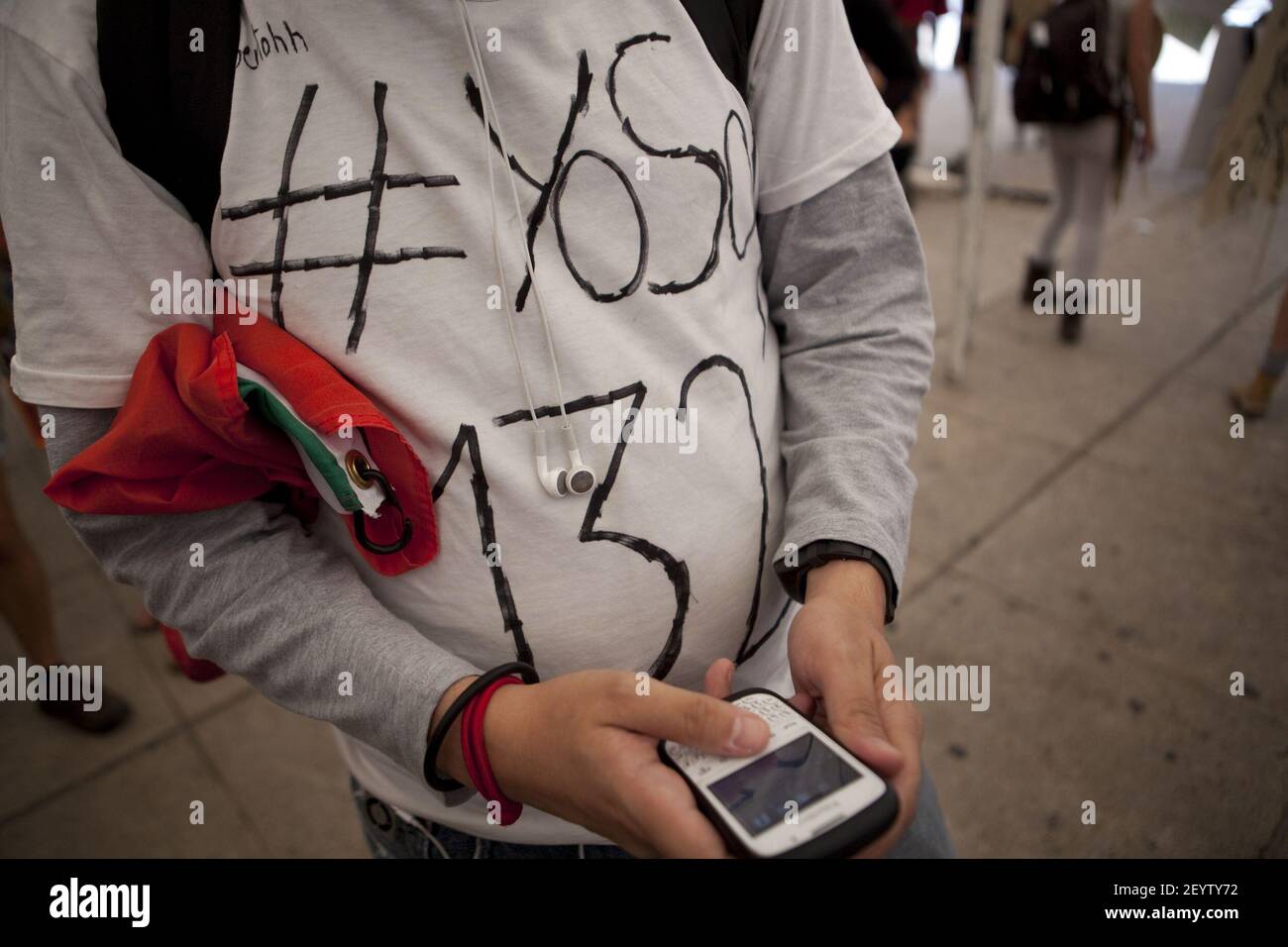10 June 2012 Ã Mexico City, Mexico Ã An university student members of the new movement 'yo soy 132' (I am 132) uses his cellphone during a protest against Enrique Pena Nieto, presidential candidate of the opposition Institutional Revolutionary Party (PRI) and media censorship in the electoral campaign before the presidential elections of July 1 at the Monument of the Angel of Independence in Mexico City. Photo credit: Benedicte Desrus / Sipa USA Stock Photo