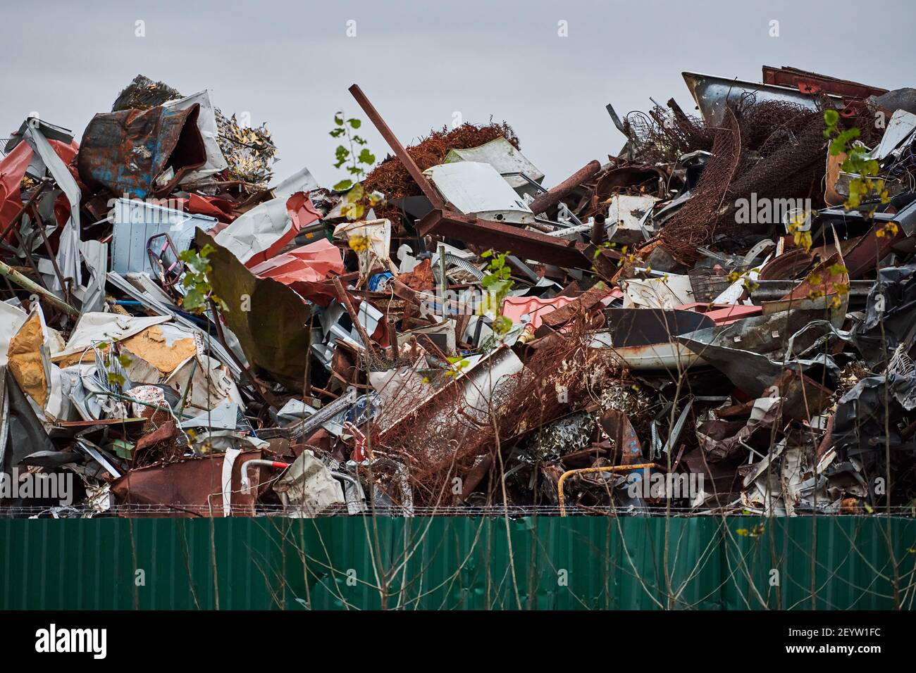 Metal scrap waste dump for recycling. City fenced landfill. Iron