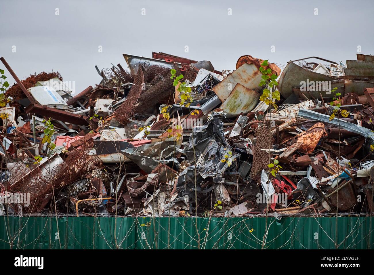 Metal scrap waste dump for recycling. City fenced landfill. Iron