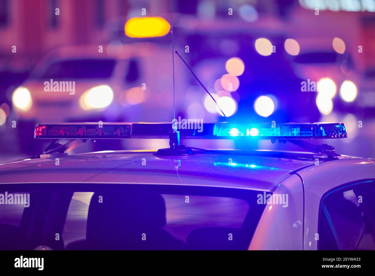 Police car lights at night city street. Red and blue lights. Road traffic accident. Evening patrolling Stock Photo