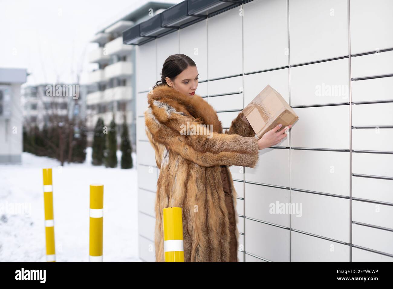 A young woman checks the correctness of the address on the package ...