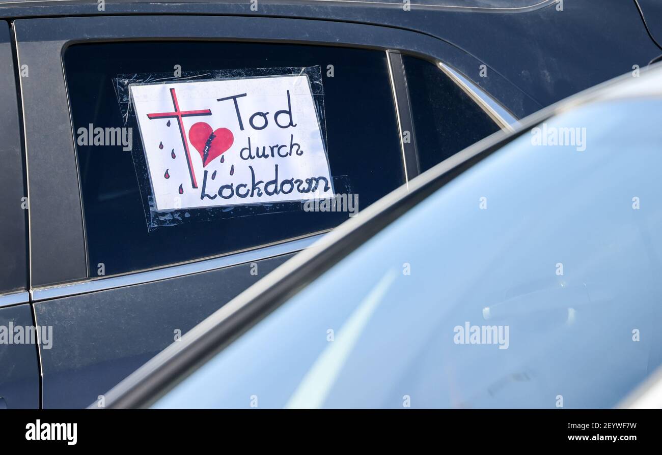 Leipzig, Germany. 06th Mar, 2021. 'Death by lockdown' is written on a note stuck to the window of a car parked before the start of a motorcade of critics of the Corona measures. In a confusing demonstration numerous motorcades with hundreds of vehicles from Dresden, Zwickau and some cities from Saxony-Anhalt are in the city. Because at the same time some counter-demonstrations were announced, the police in Leipzig prepared for a large-scale operation. Credit: Jan Woitas/dpa-Zentralbild/dpa/Alamy Live News Stock Photo