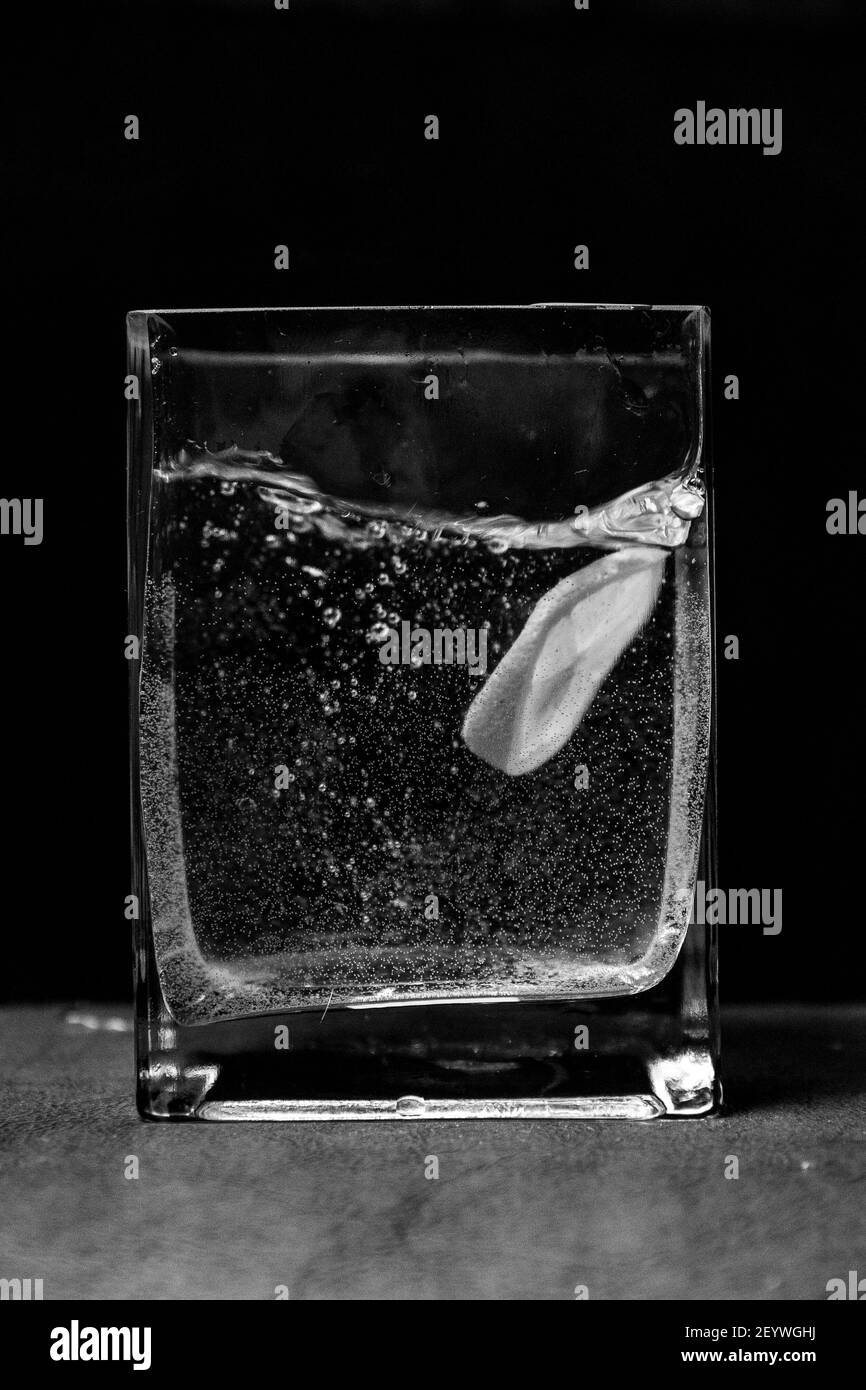 lemon in a cut in water in a glass on a black background Stock Photo