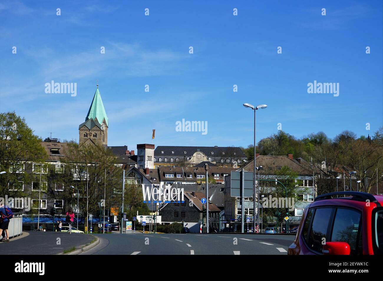 Essen Werden, NRW, Germany: Seen from und bridge over the river Ruhr. The Tower of the Werden cathedral is to be seen with the light green roof made of copper. Stock Photo