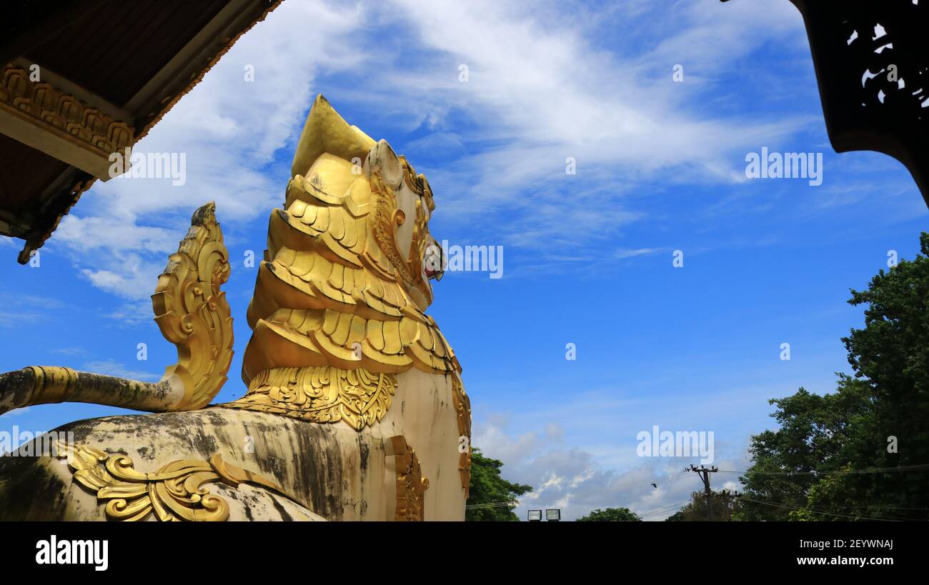 A Chinthe, stylized giant leogryph (lion-like creature) that guards the entrance of the Shwedagon Pagoda, Yangon Myanmar Stock Photo