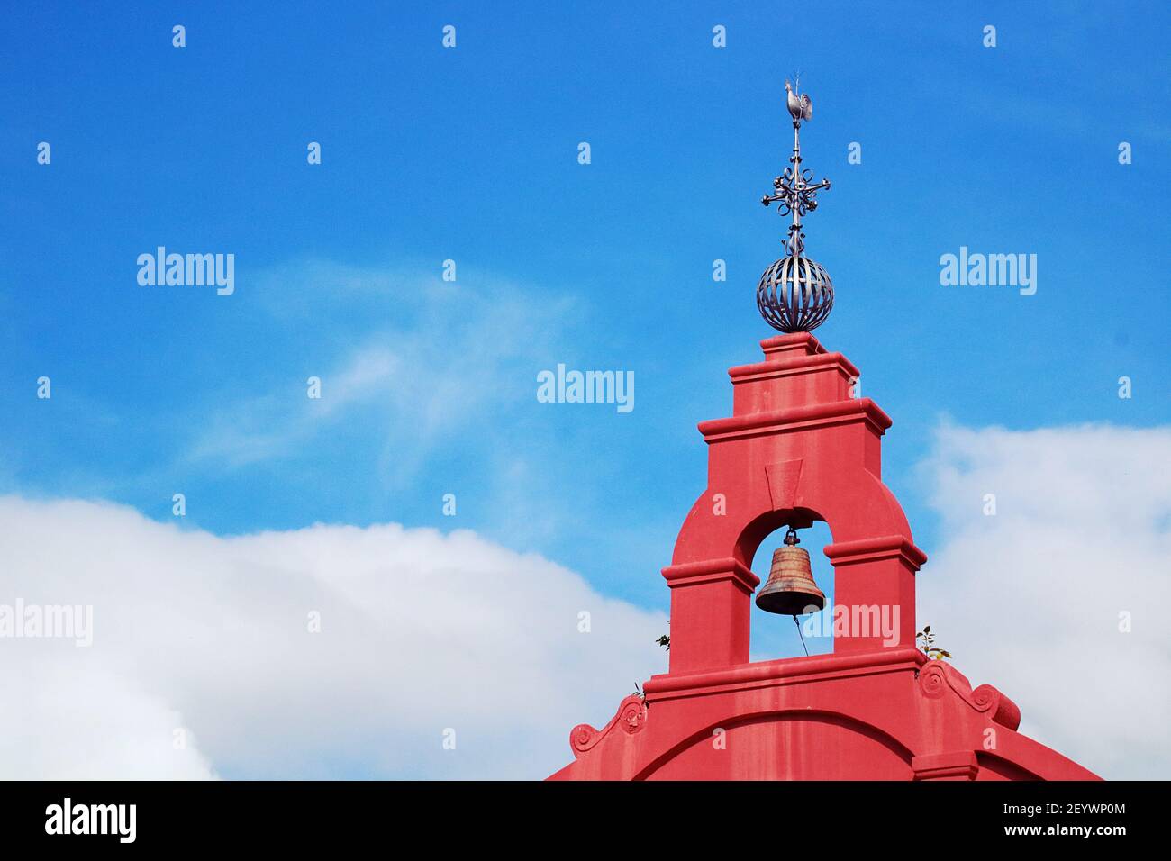 Metal Wind Vane with rooster ornament on top of a church bell tower Stock Photo