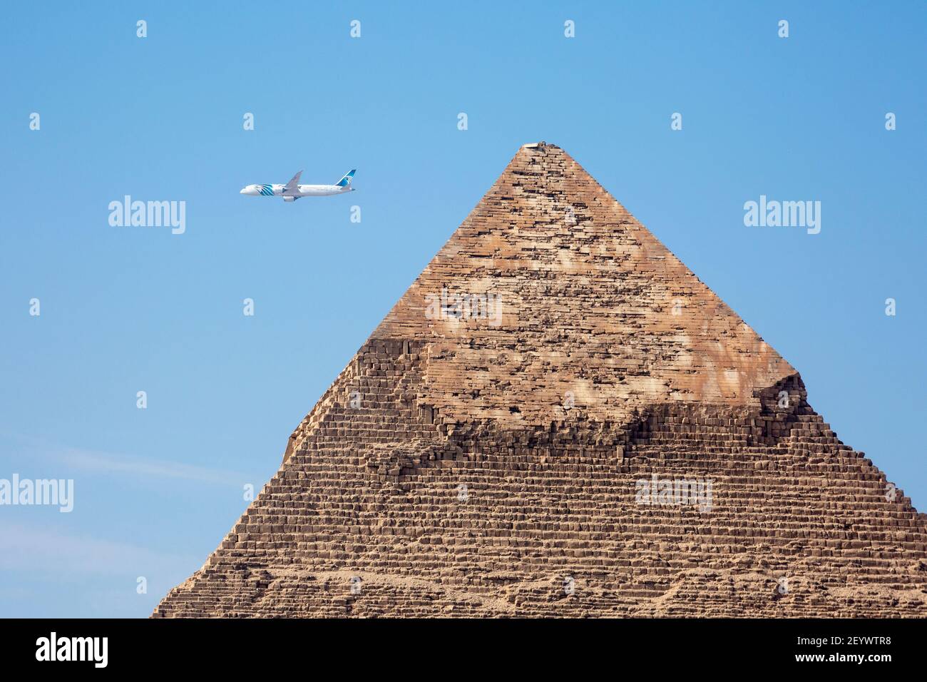 View of a plane passing behind the Pyramid of Khafre, Giza Plateau, Greater Cairo, Egypt Stock Photo