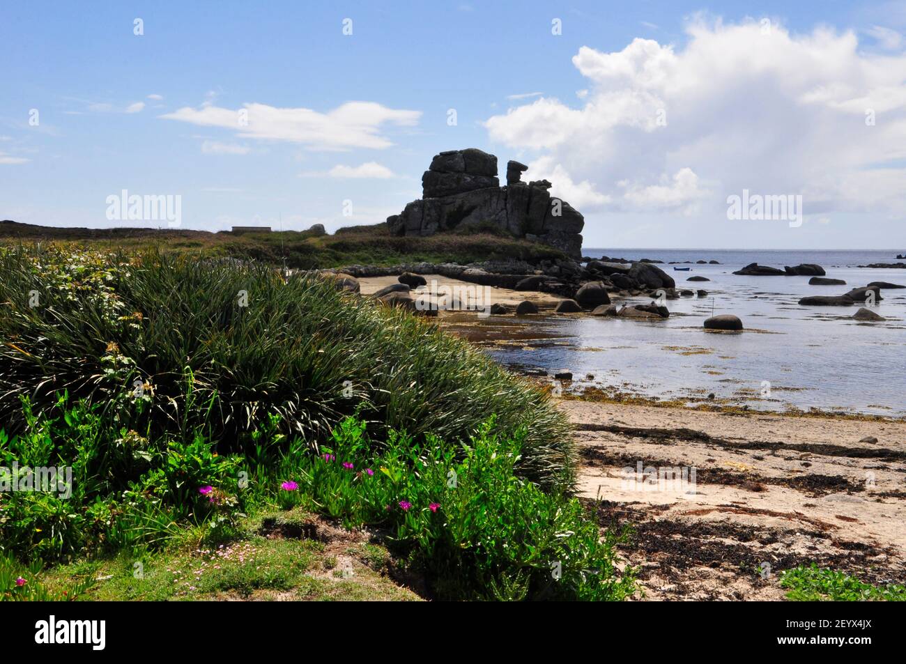 Tide going out from Porth Hellick passing the rock formation known as the Loaded Camel on the island of St Mary's, isles of Scilly,Cornwall.UK Stock Photo