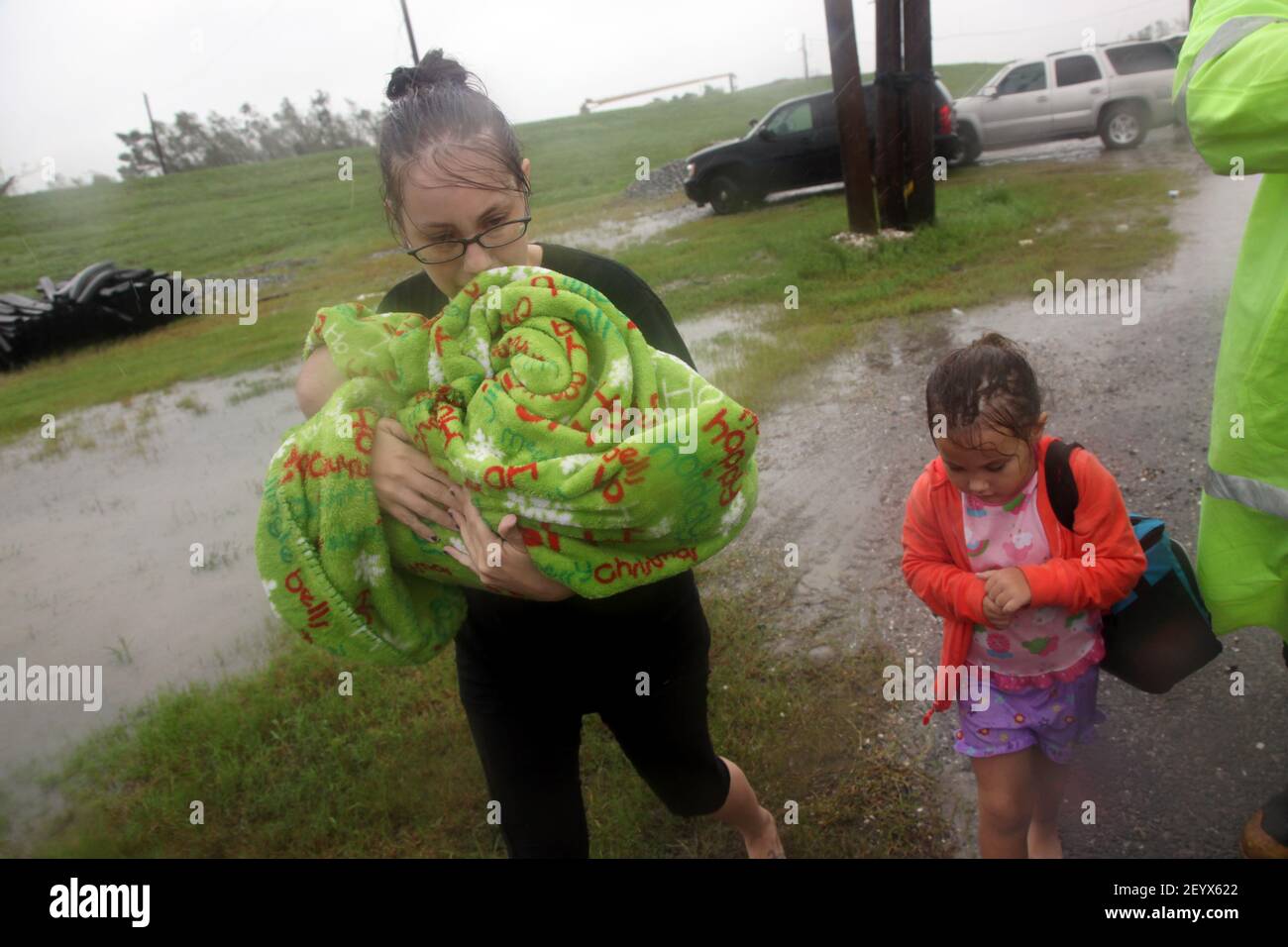 29 August 2012. Braithwaite, Plaquemines Parish, Louisiana, USA. Emergency evacuations. A young mother, her baby and daughter are rescued from the floods as hurricane Isaac batters the community of Braithwaite in Plaquemines Parish A levee was overtopped and the water gushed in, inundating peoples houses on the 7th year anniversary of Hurricane Katrina. Photo Credit: Charlie Varley/Sipa USA ***NO UK SALES*** Stock Photo