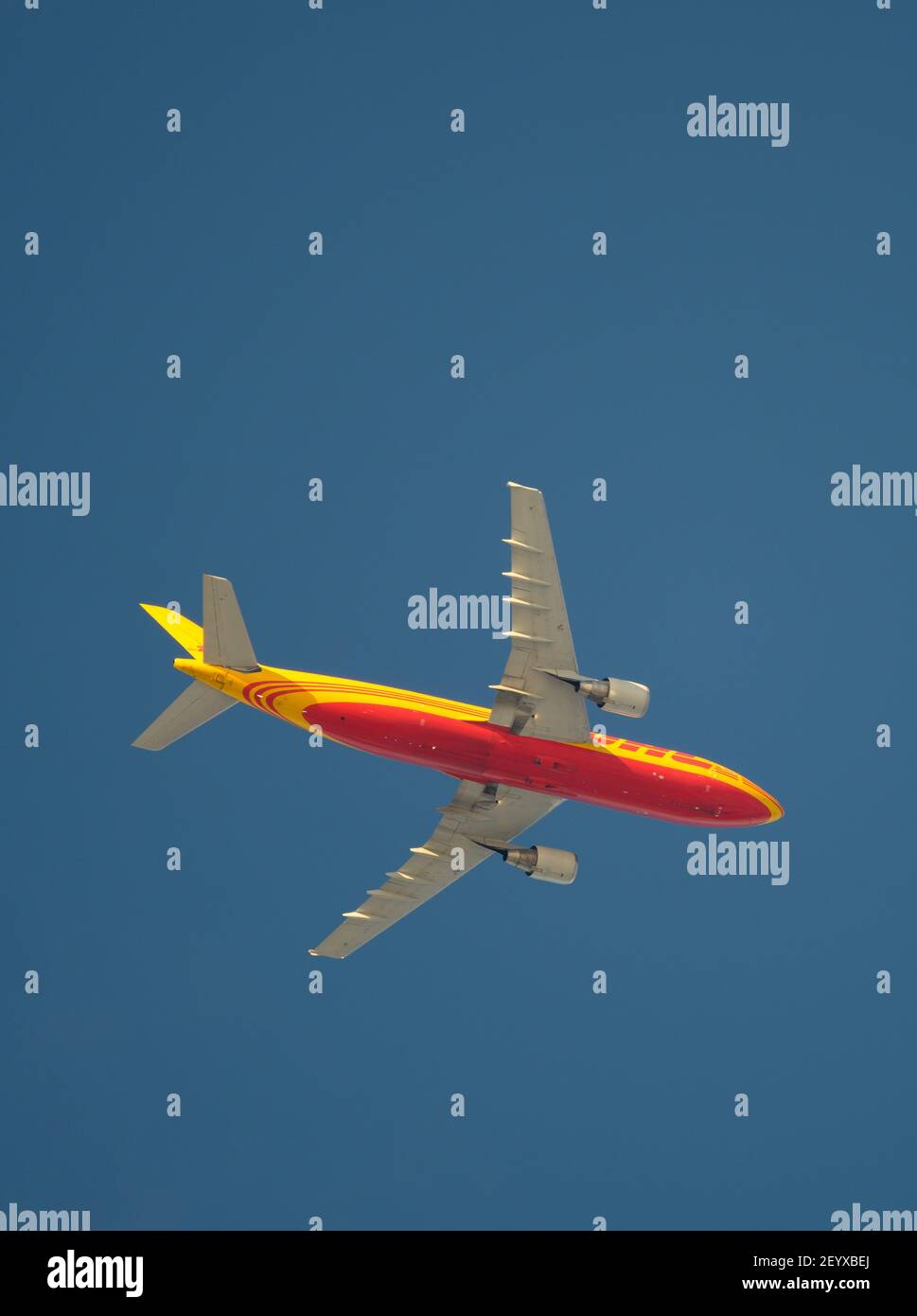 London, UK. 6 March 2021. Distinctive livery of a DHL Airbus A300B4 cargo flight as it climbs out of London Heathrow airport en route to Frankfurt. Credit: Malcolm Park/Alamy Live News Stock Photo