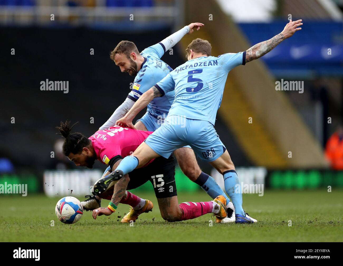 Derby County's Colin Kazim-Richards (floor) battles for the ball with Coventry City's Kyle McFadzean (right) and Liam Kelly during the Sky Bet Championship match at St. Andrew's Trillion Trophy Stadium, Birmingham. Picture date: Saturday March 6, 2021. Stock Photo