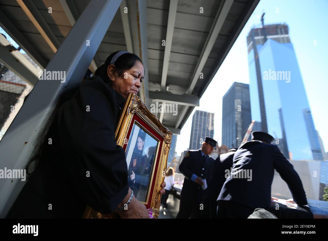 11 September 2012 - New York, NY - Julia Rivas cried and held her son's picture, Moises N. Rivas who worked at the World Trade Center during Commemoration Ceremony of the 11th Anniversary of September 11th by the North Pool at World Trade Center. The building on the right is 2 World Trade Center being built. Photo Credit: Chang W. Lee/Pool/Sipa Press Stock Photo