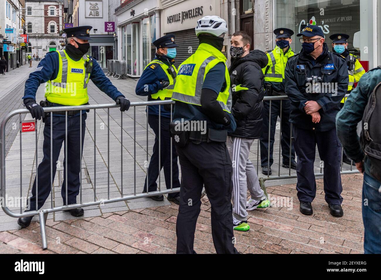 Cork, Ireland. 6th Mar, 2021. Around 700 people attended an anti-lockdown rally held in Cork city centre today. Gardai were prepared for any trouble with officers in the city centre from 10.30am. A member of the public was ushered away from the protest by uniformed Gardai. Credit: AG News/Alamy Live News Stock Photo