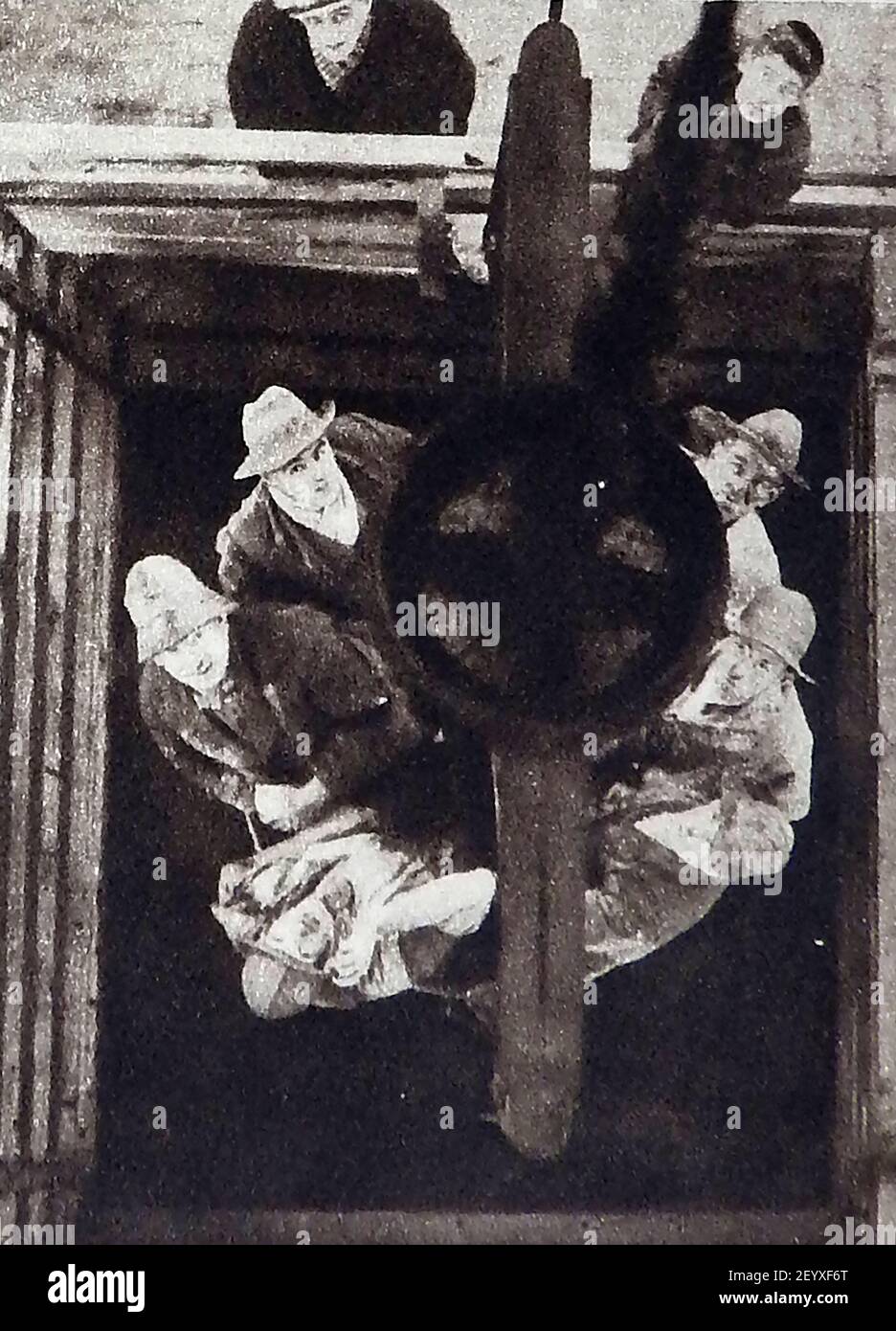 Circa 1940s - American coal miners being hauled up  to the surface through the lift shaft Stock Photo