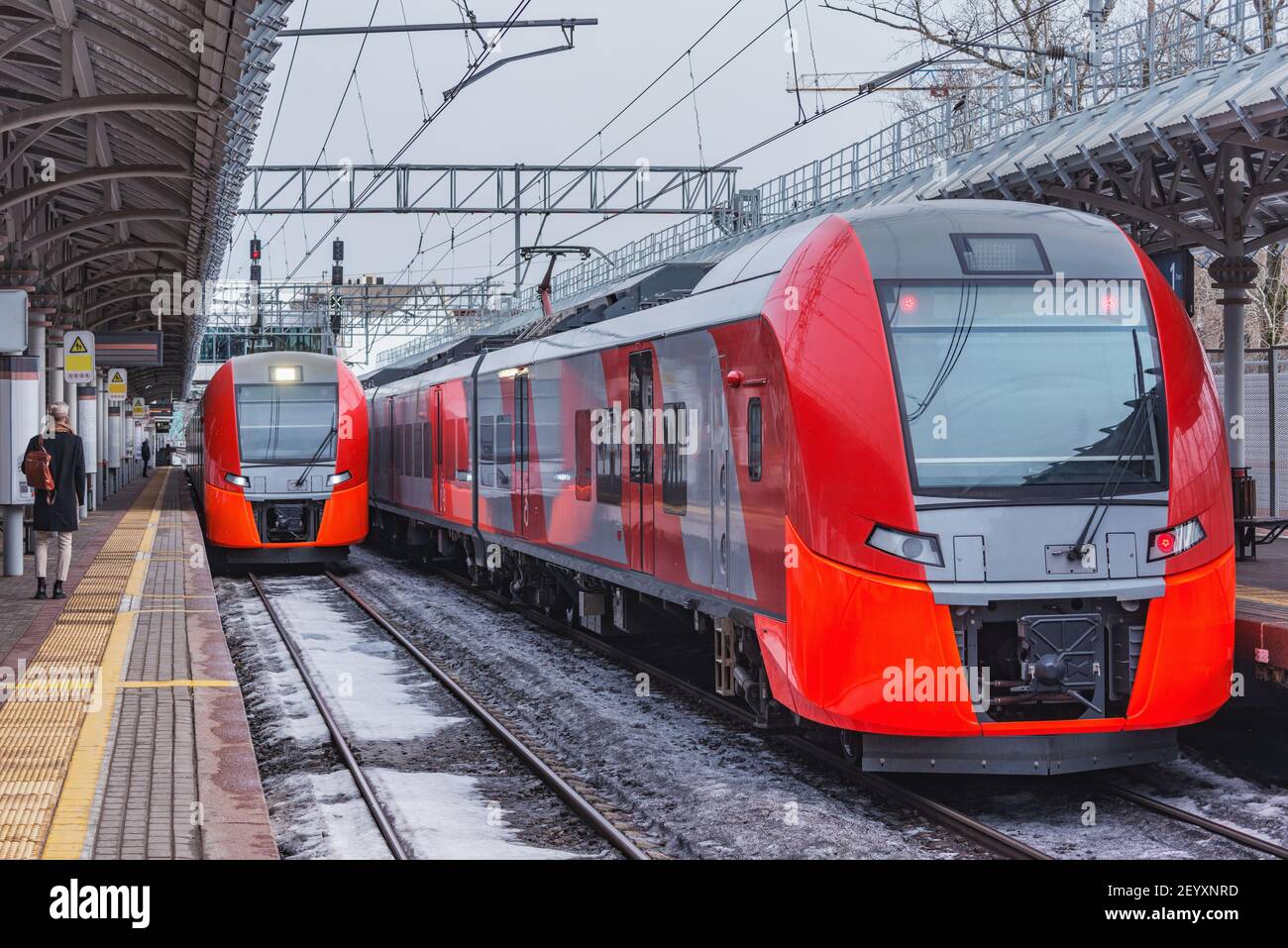 Highspeed trains stand by the station platform at winter day. Stock Photo