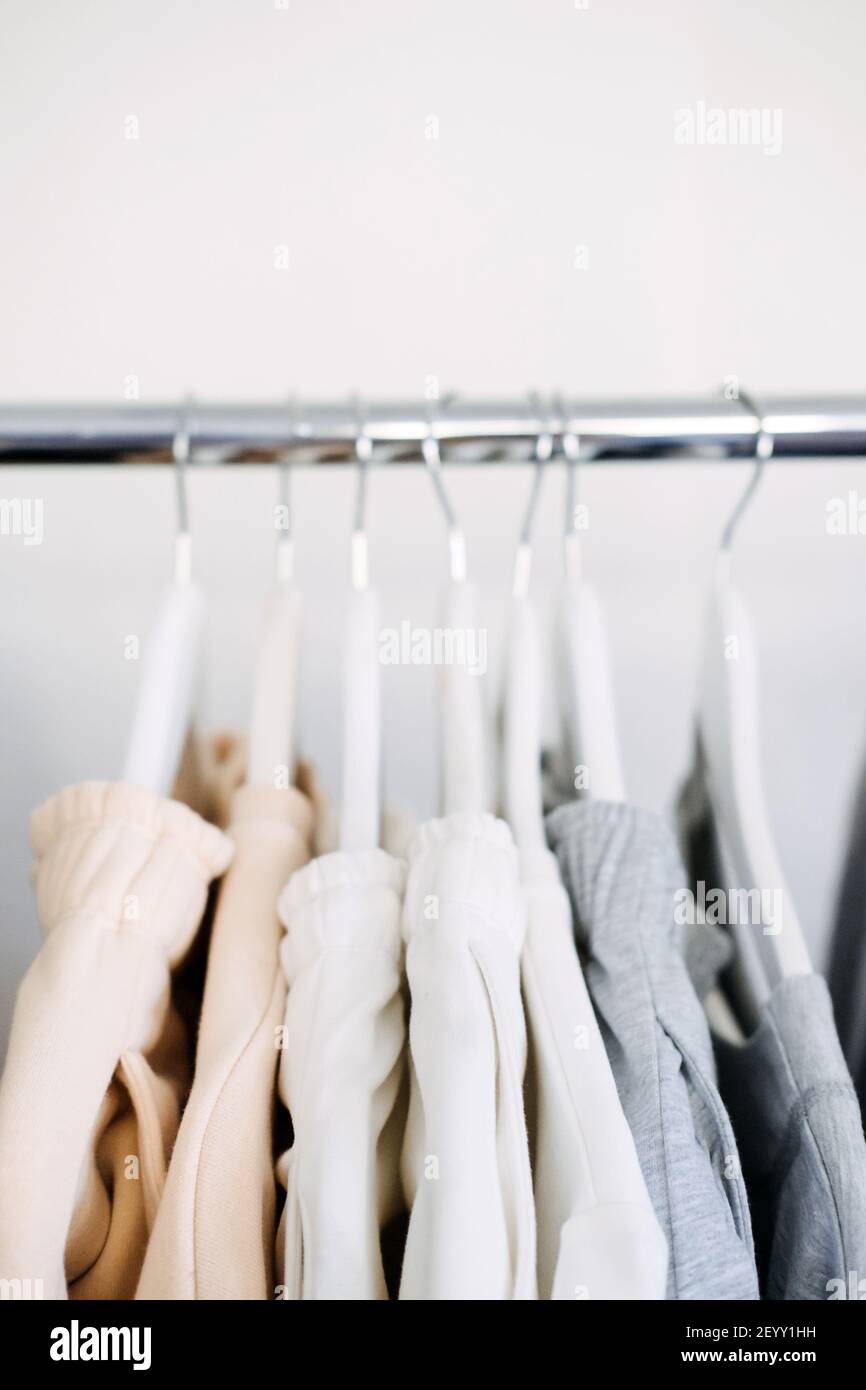Circular Economy, Second hand, Fast fashion, Sustainable fashion. Many second hand clothes hanged on clothes rack Stock Photo