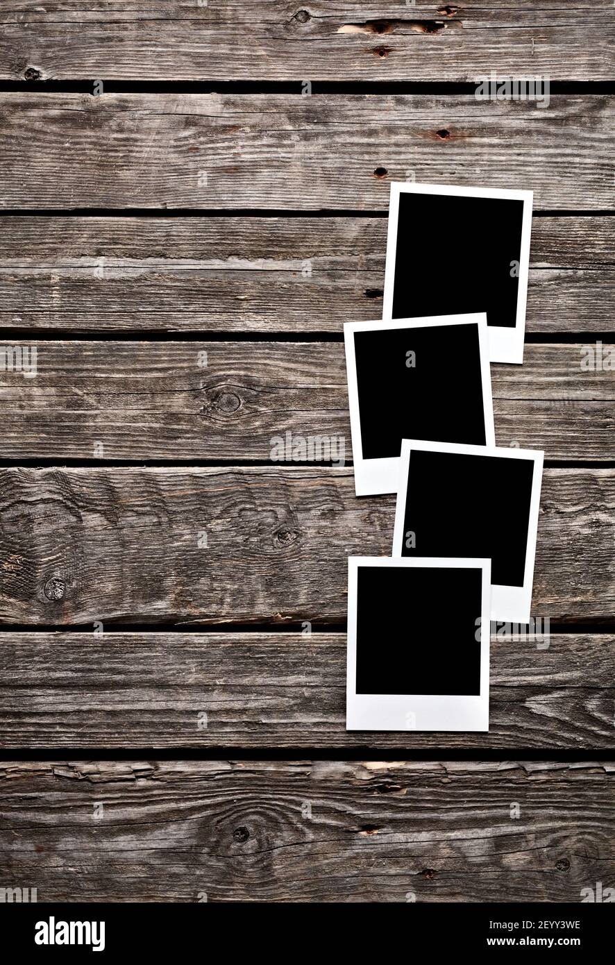 Blank photo frames on wooden background. Stock Photo