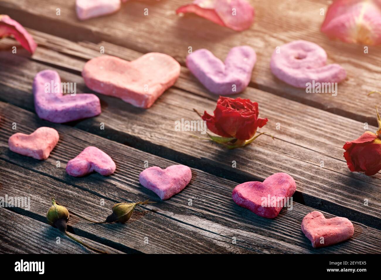 Word Love with rose petals and small heart Stock Photo