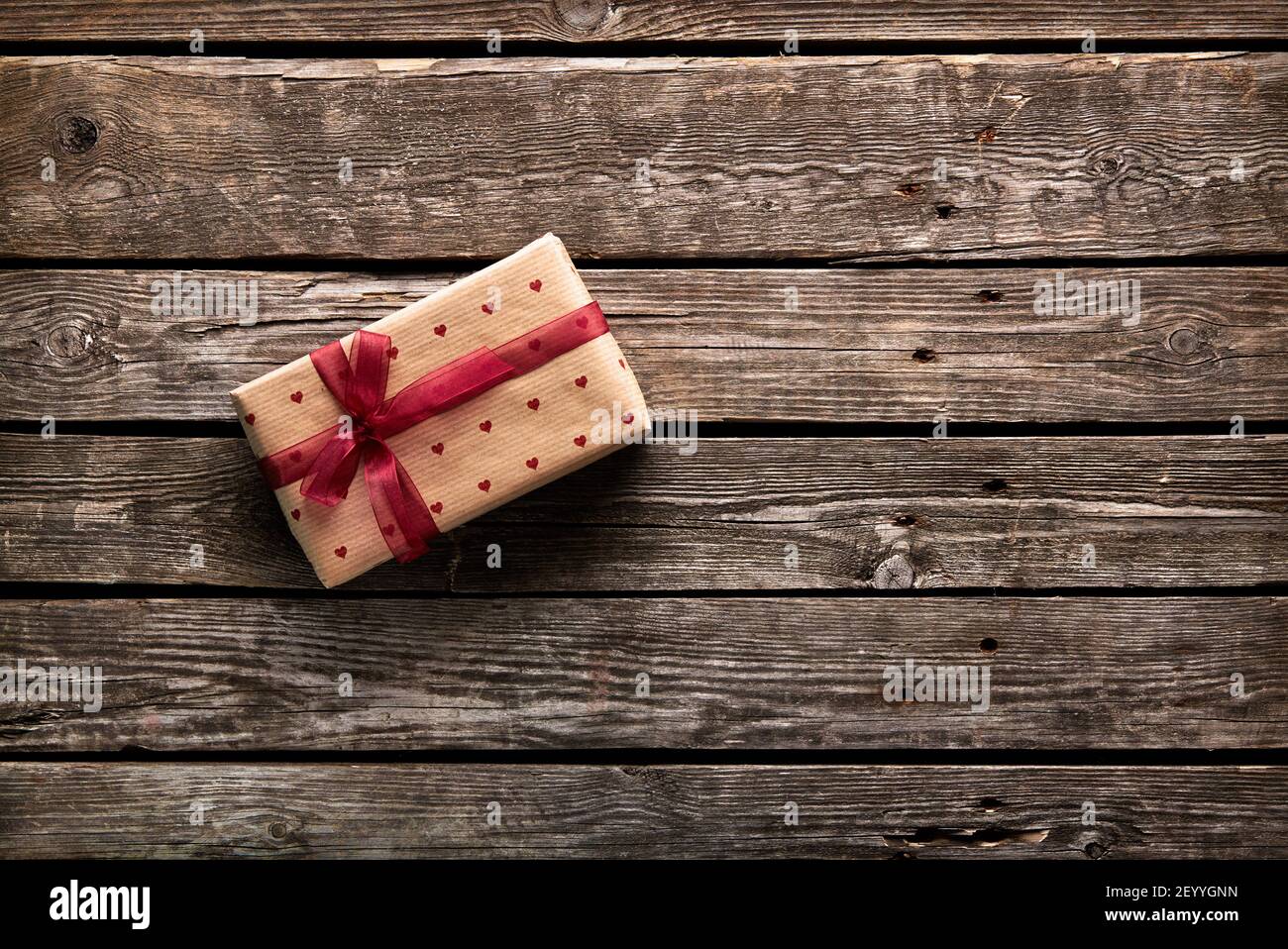Gift box tied red ribbon with small hearts Stock Photo