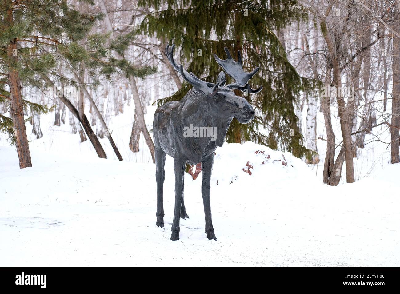 Wrought iron moose in the park. Big black sculpture on the street. Bashkiria in the winter. Stock Photo