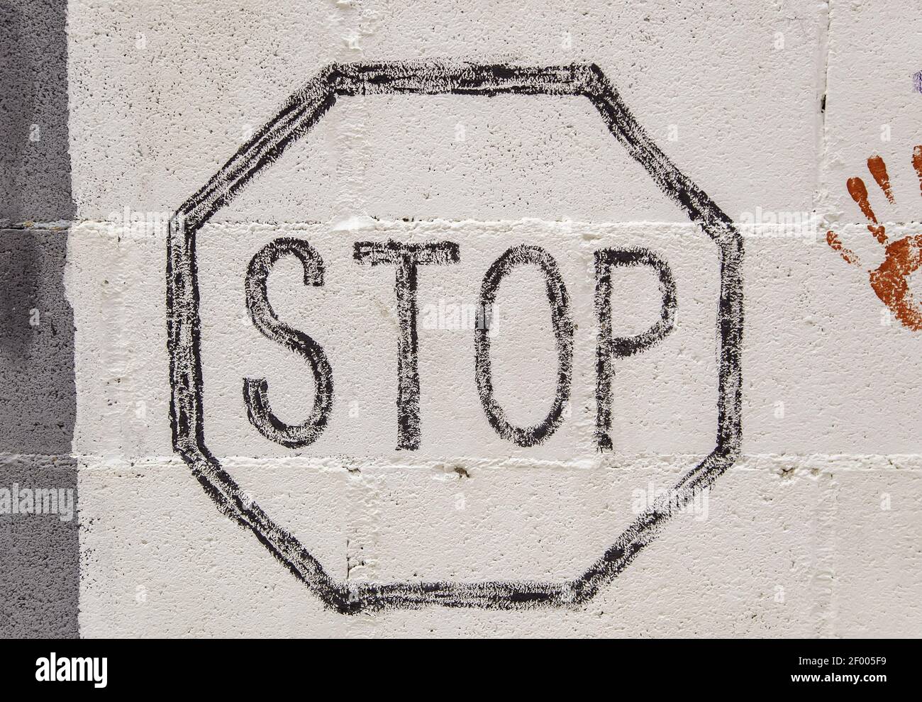 Stop sign painted on wall, texture and background, traffic Stock Photo