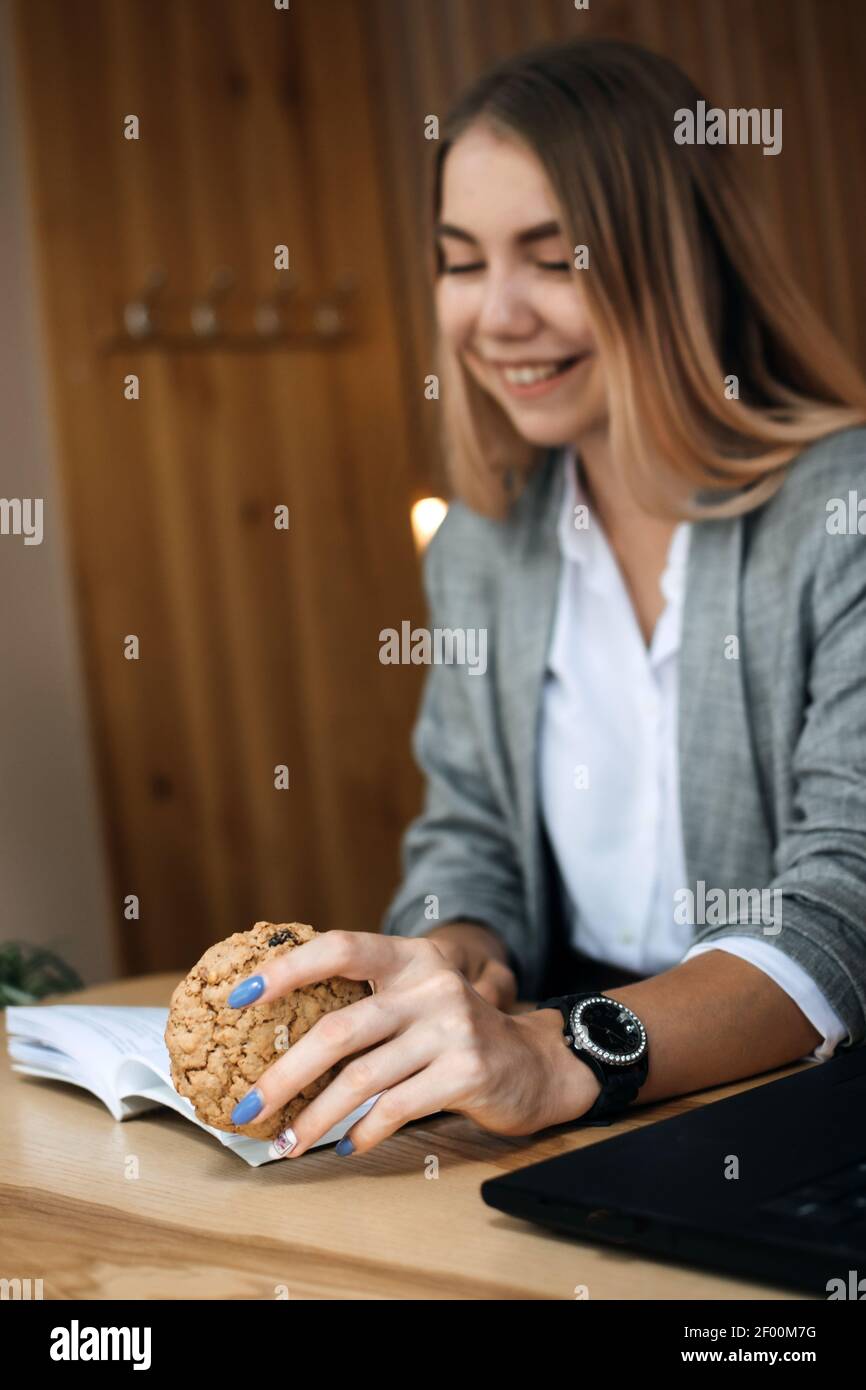 Foods to Boost Brain and Memory. Foods linked to better brainpower. Young girl, teen, student with open book in her hands and healthy grain cookies Stock Photo