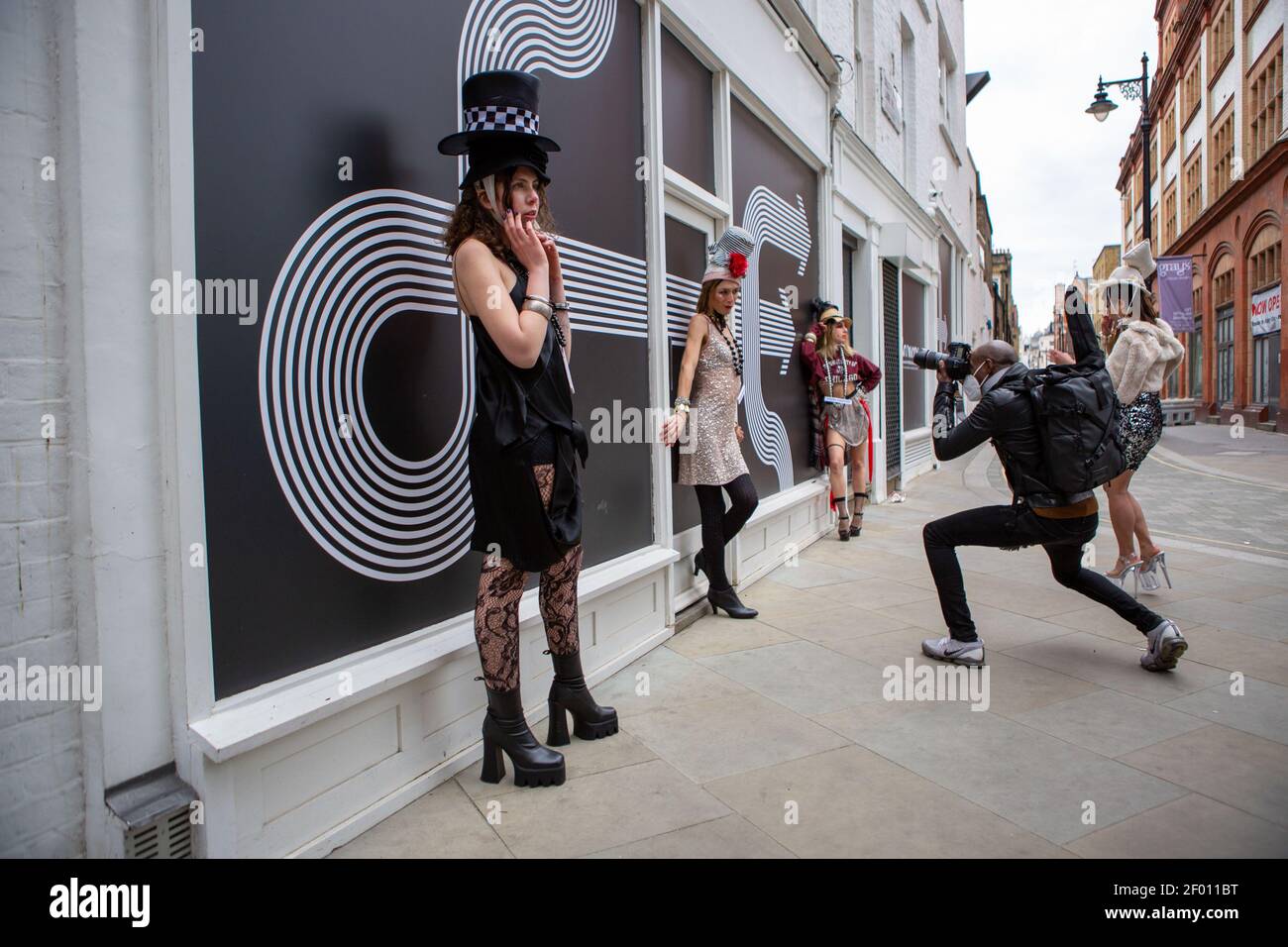 Models showcase Pierre Garroudi's latest colorful collection at one of the designer's specialty flash mob fashion shows in Bond Street,  London. Stock Photo