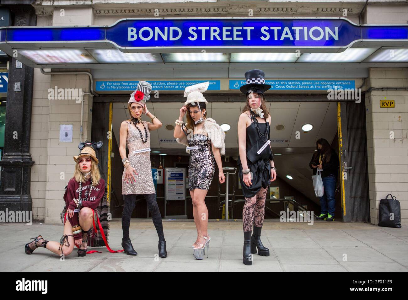 Models showcase Pierre Garroudi's latest colorful collection at one of the designer's specialty flash mob fashion shows in Bond Street,  London. Stock Photo