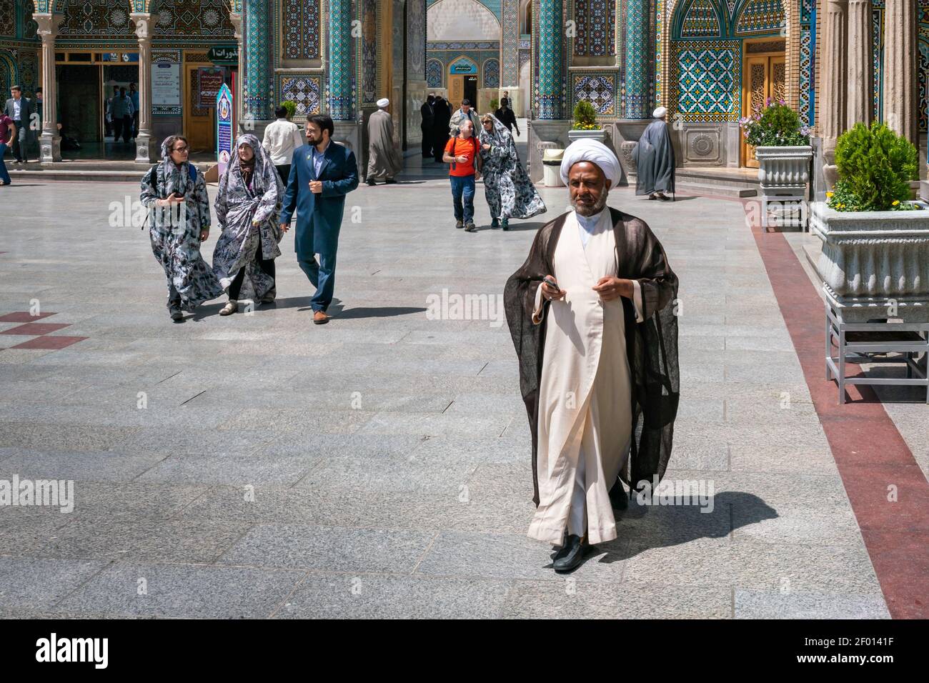 Qom, Iran - 04.20.2019: Islamic clergy in traditional dress walking in