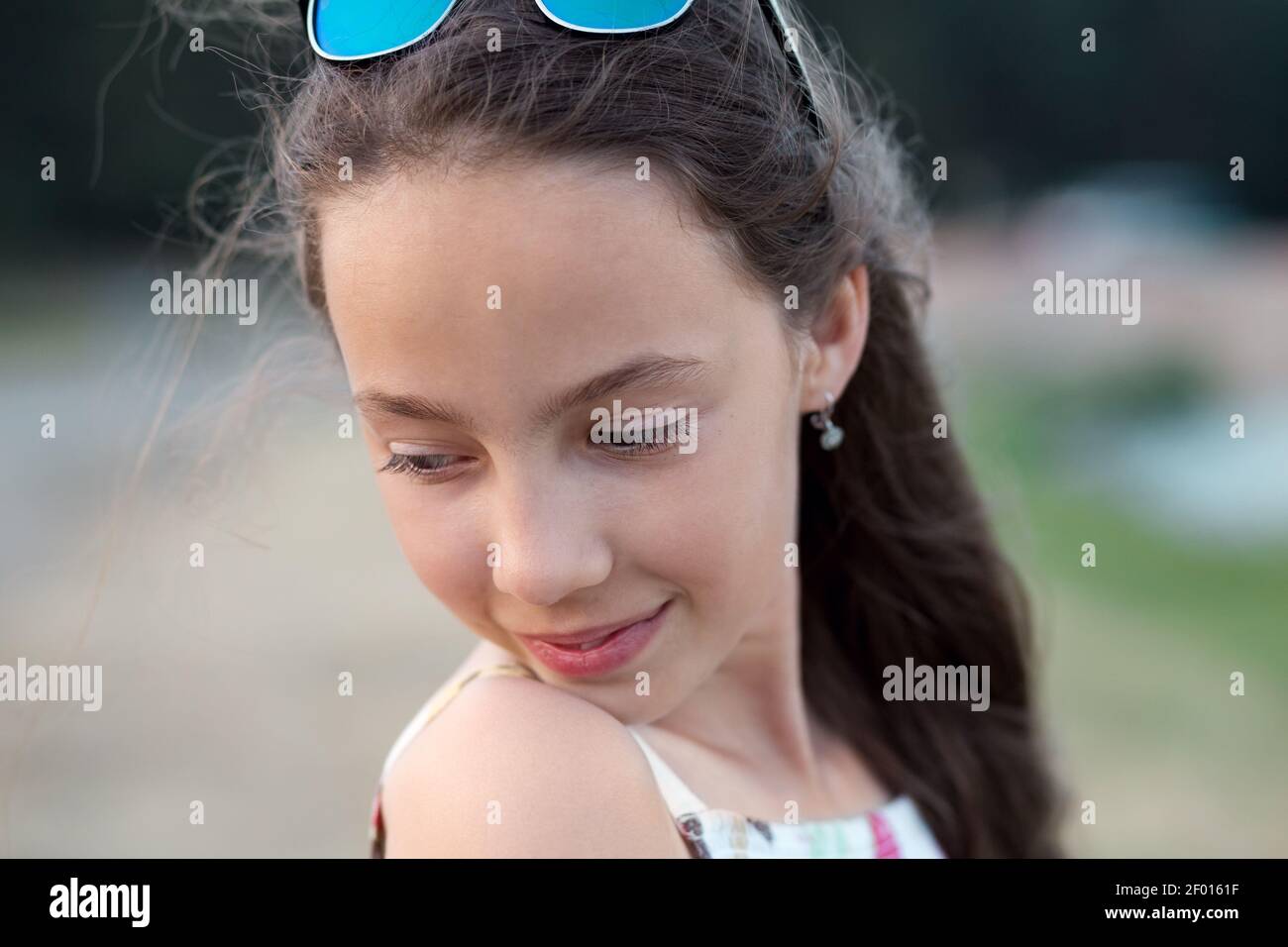 Portrait of beautiful serious teenager girl, looking down. Stock Photo