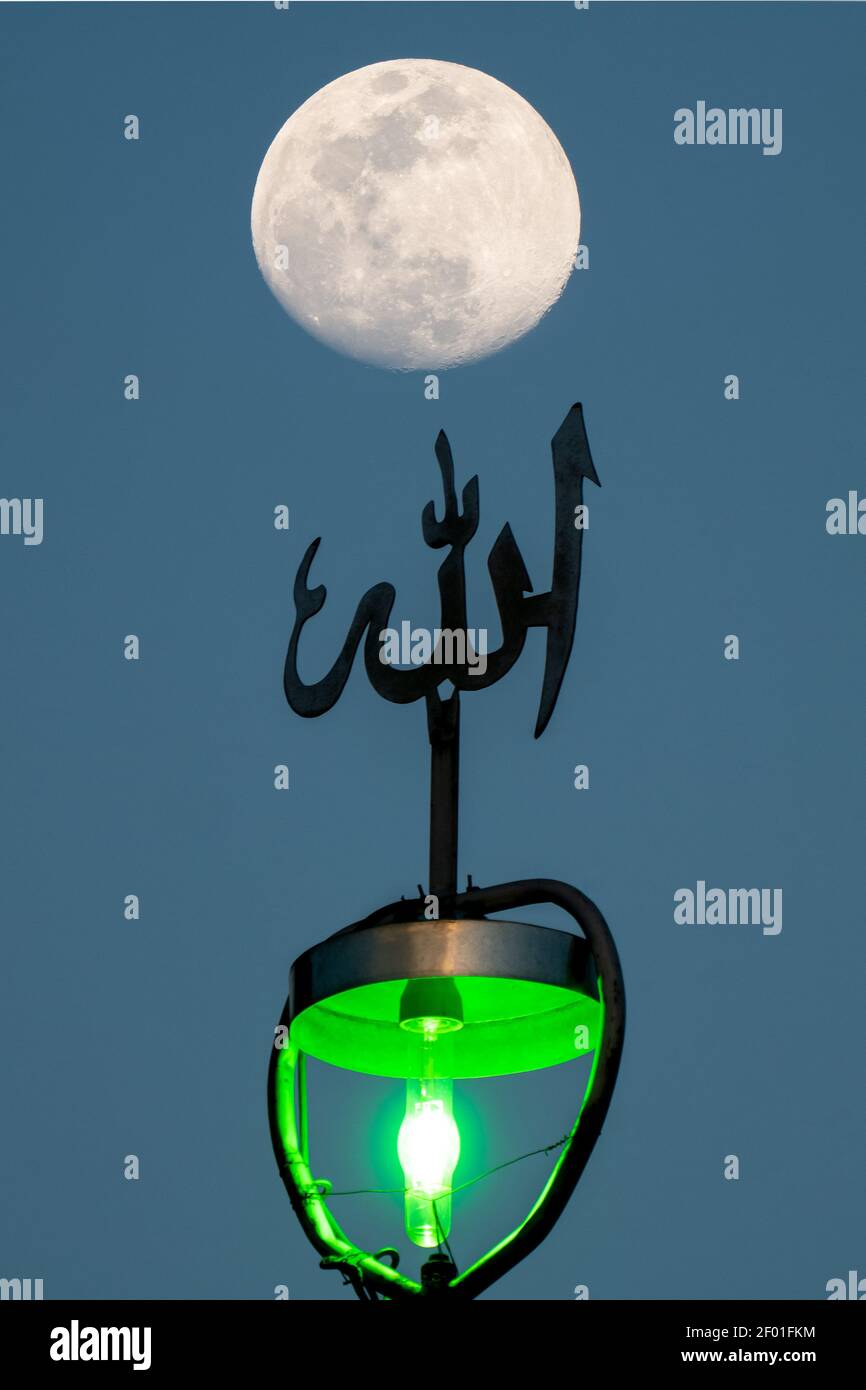 A full moon shining above islamic ornament. Mystical evening in ancient Persia. God, soul and universe. Stock Photo