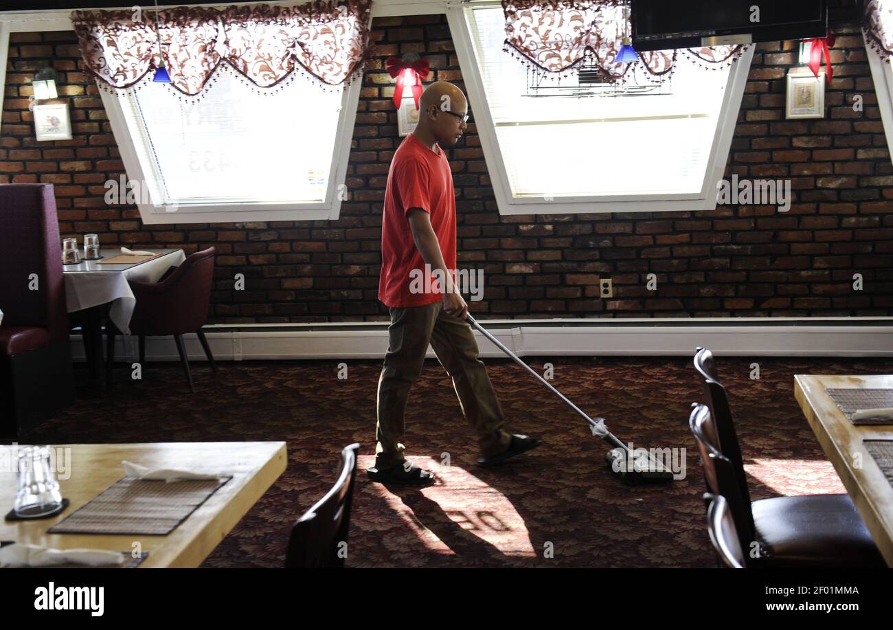 Mitchell Xayapraseuth vacuums the floor at Thai Town in Anchorage