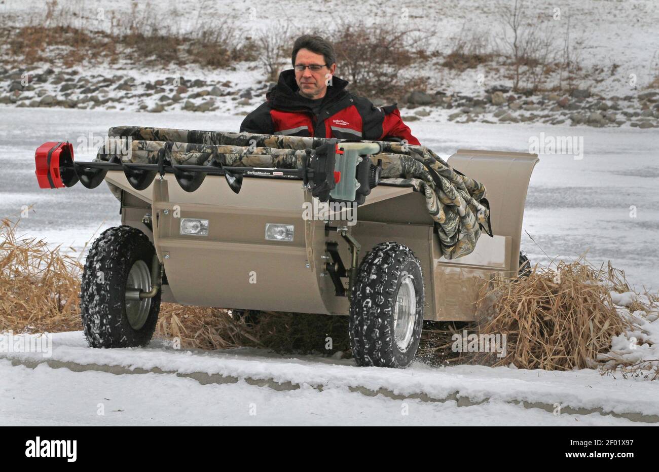Tom Roering, president of Multifarious, demonstrates the company's Wilcraft  which is a mobile ice fishing platform that offers the safety of being able  to float if you break through the ice. (Photo