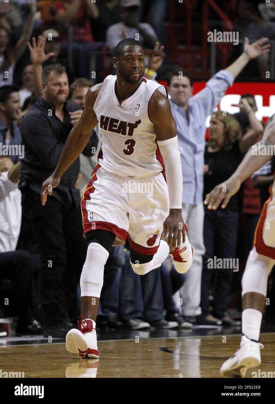 The Miami Heat's Dwyane Wade brings the crowd to its feet with a basket ...