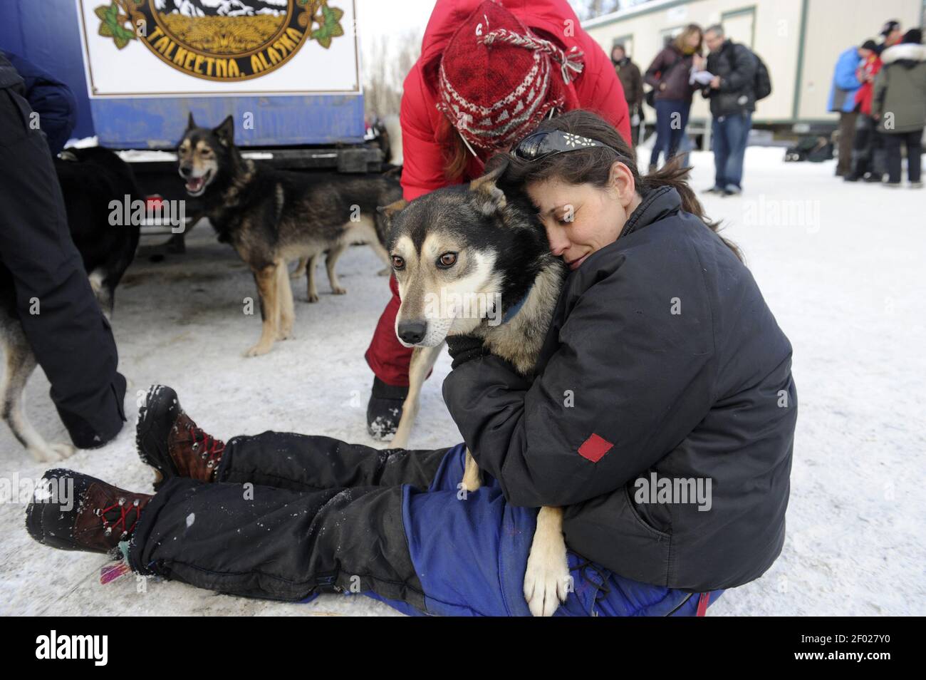 Iditarod musher Karin Hendrickson hugs one of her team members as
