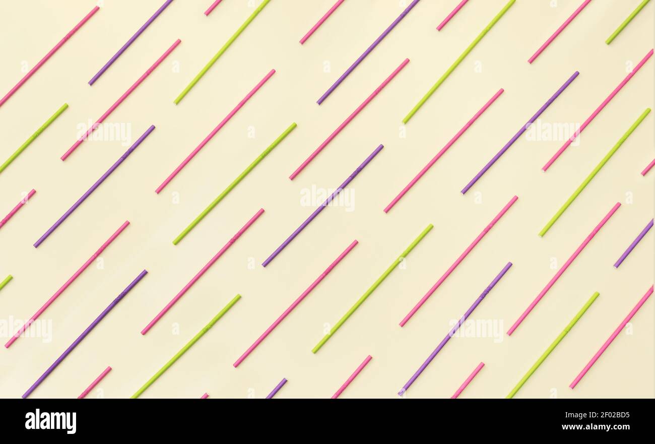 Multi colored paper straws lined up  in a pattern on a champagne background. Flat lay view, modern creative concept. Stock Photo