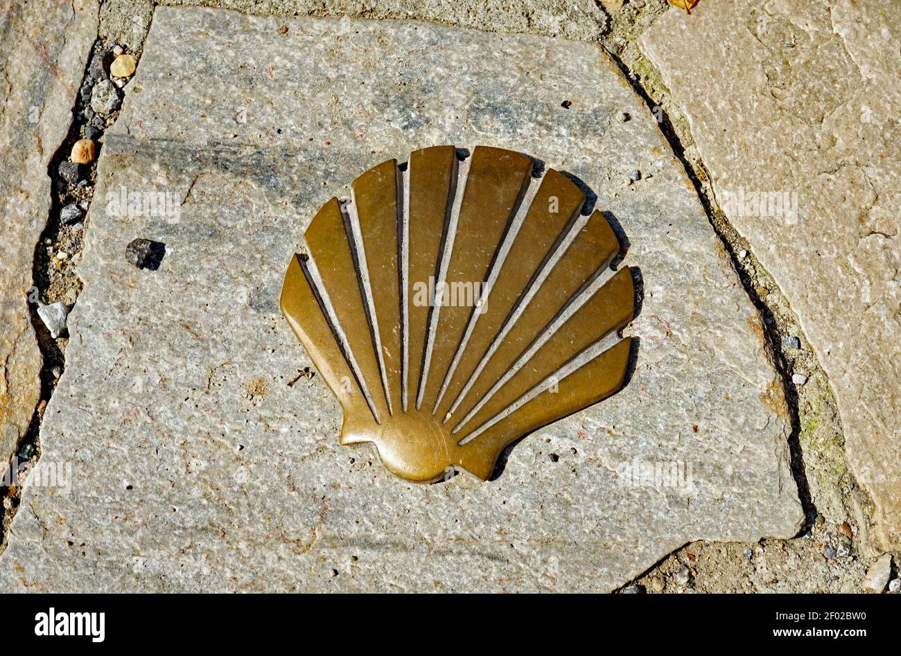 Shell - St. James shell - made of metall as a symbol for the Way of St. James, fixed to stone slabs of the side walk, 2020 Stock Photo