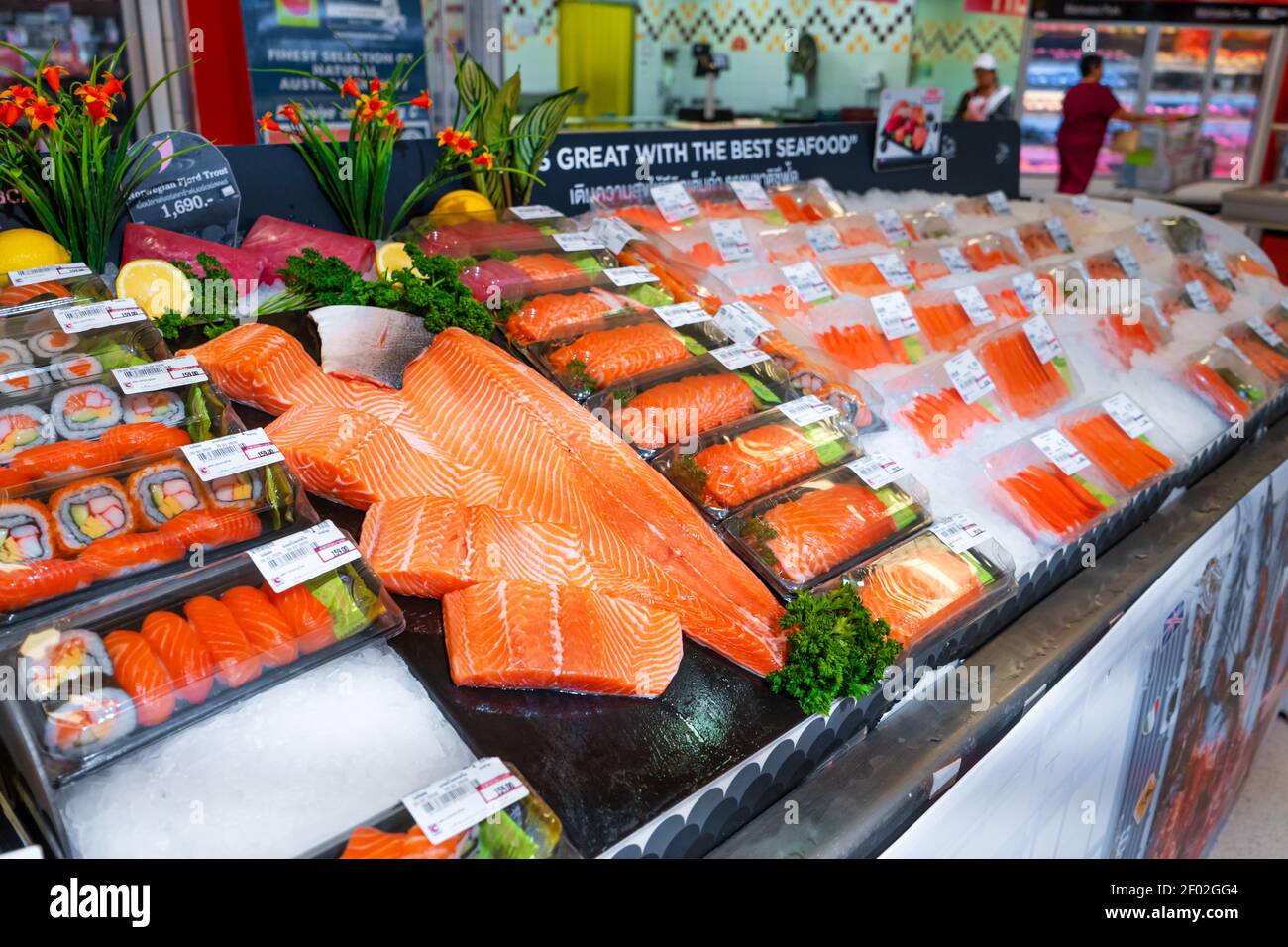 Fresh salmon fillets on a shelf in the fish section of a grocery store